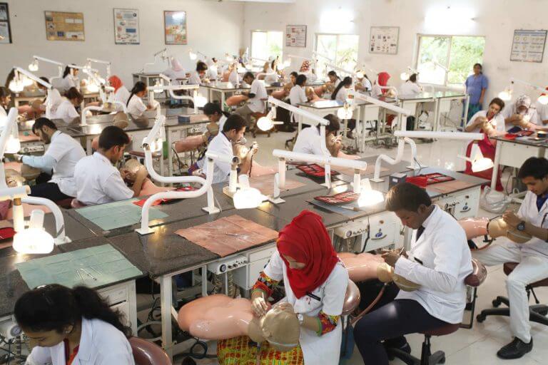 Dental students practicing in a dental laboratory